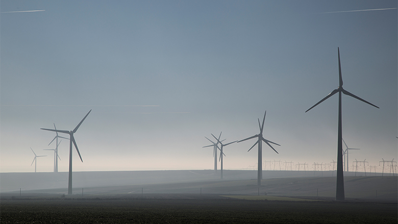 wind turbines in fog from distance